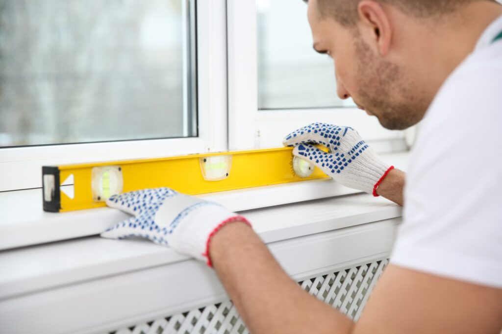 New window installation a worker measuring that balance of the window pane